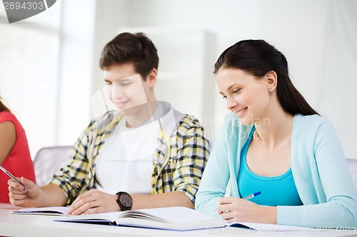 Image of students with textbooks and books at school