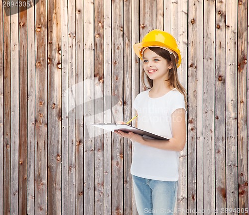 Image of smiling little girl in hardhat with clipboard