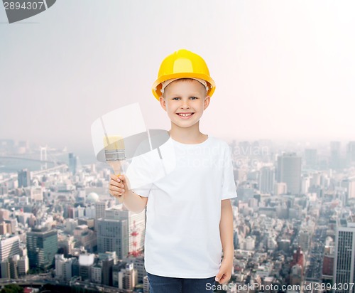 Image of smiling little girl in helmet with paint brush