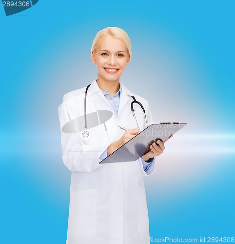 Image of smiling female doctor with clipboard