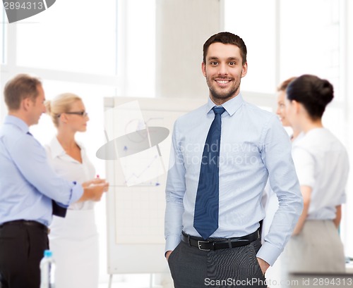 Image of group of smiling businessmen with smartboard