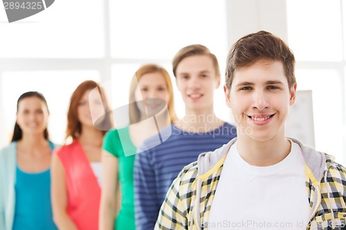 Image of smiling male student with group of classmates