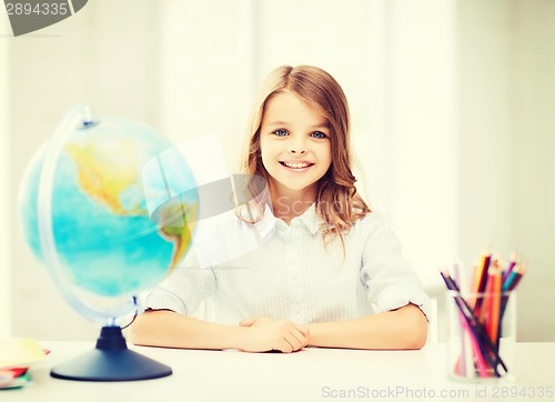 Image of student girl with globe at school