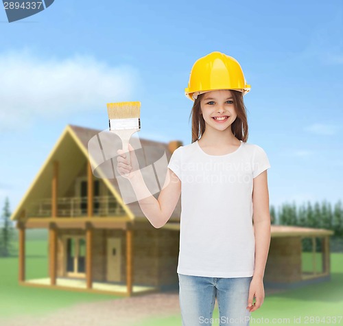 Image of smiling little girl in helmet with paint brush