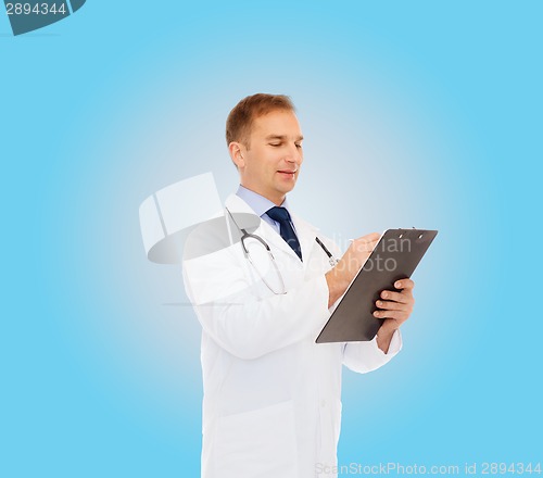 Image of smiling male doctor with clipboard and stethoscope