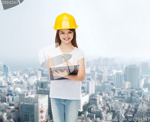 Image of smiling little girl in hardhat with clipboard