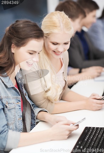 Image of students with computer monitor and smartphones