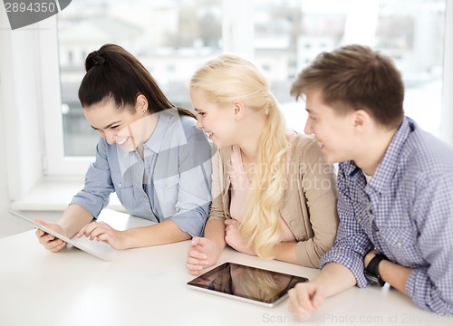 Image of smiling students with tablet pc computer at school