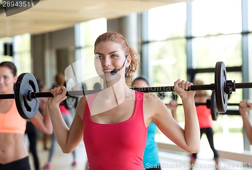 Image of group of women with barbells in gym