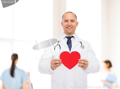 Image of smiling male doctor with red heart and stethoscope