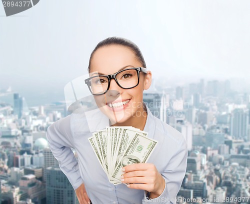 Image of smiling businesswoman with dollar cash money