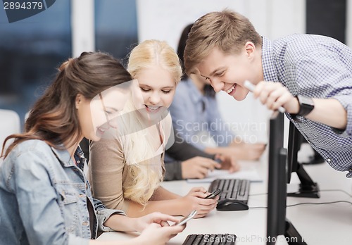 Image of students with computer monitor and smartphones