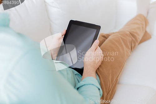 Image of close up of man with tablet pc computer at home