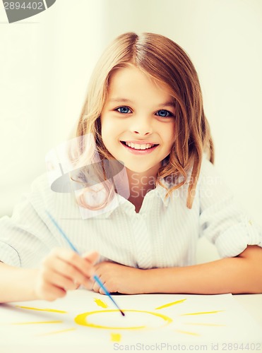 Image of little girl painting at school