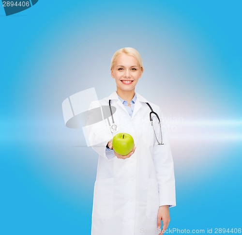 Image of smiling female doctor with green apple