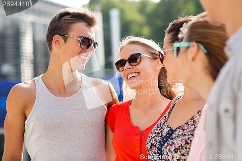 Image of group of smiling friends in city