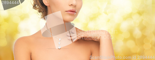 Image of woman wearing shiny diamond pendant