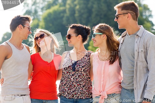 Image of group of smiling friends in city