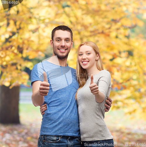 Image of smiling couple showing thumbs up