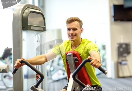 Image of smiling man exercising in gym