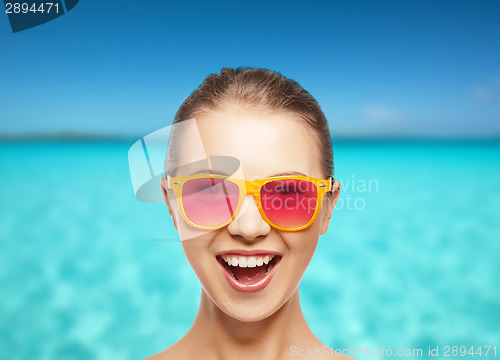 Image of happy teenage girl in pink sunglasses