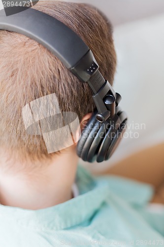 Image of close up of man in headphones at home