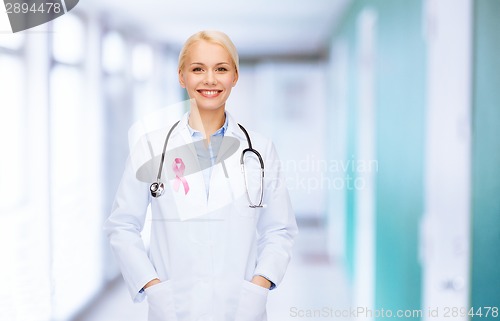 Image of doctor with stethoscope, cancer awareness ribbon