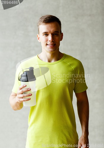 Image of smiling man with protein shake bottle