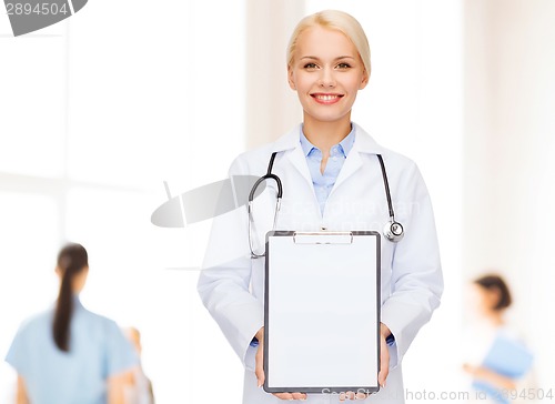 Image of smiling female doctor with clipboard