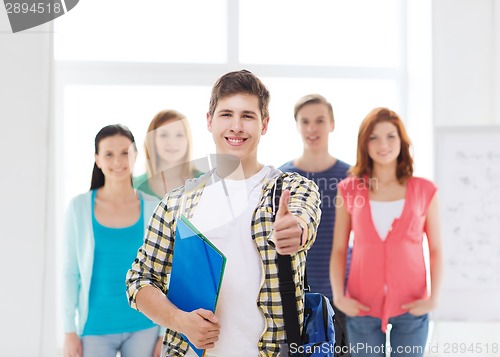 Image of male student with classmates showing thumbs up