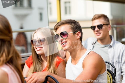 Image of smiling couple traveling by tour bus