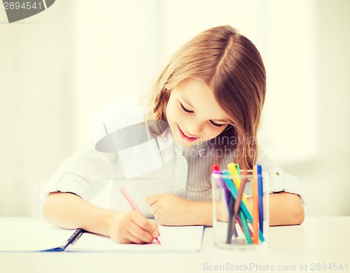 Image of little student girl drawing at school