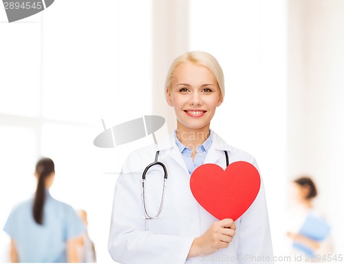 Image of smiling female doctor with heart and stethoscope