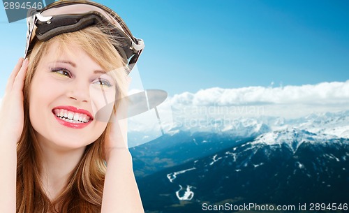 Image of smiling teenage girl in snowboard goggles