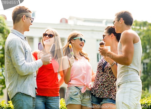 Image of group of smiling friends with ice cream outdoors