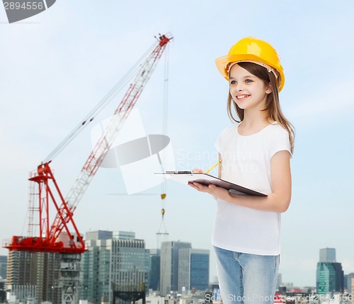 Image of smiling little girl in hardhat with clipboard