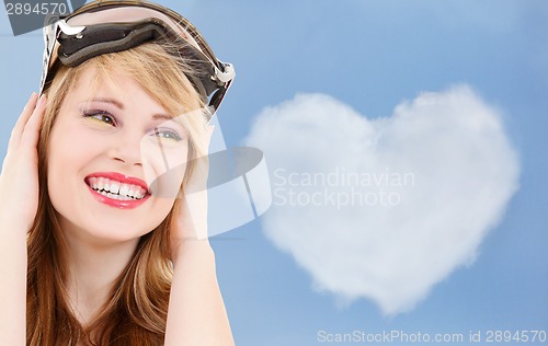 Image of smiling teenage girl in snowboard goggles