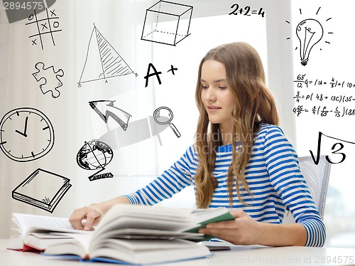 Image of smiling student girl reading books at home