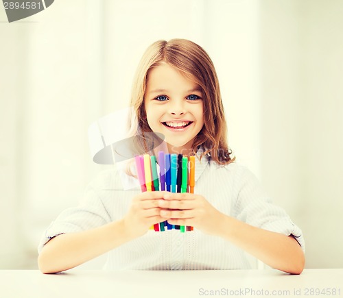 Image of girl showing colorful felt-tip pens