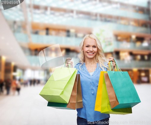 Image of smiling woman with many shopping bags