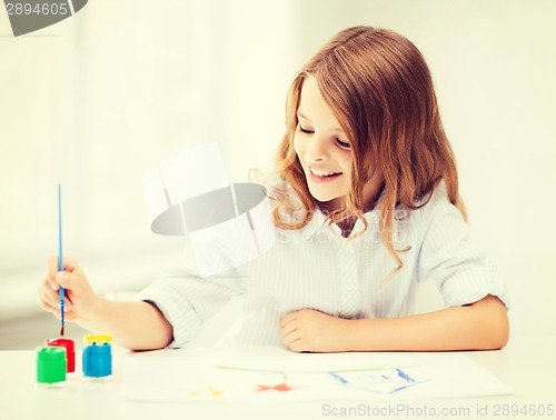 Image of little girl painting at school