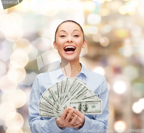 Image of laughing businesswoman with dollar cash money