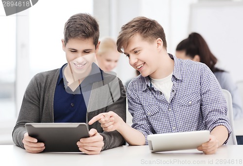 Image of students looking at tablet pc in lecture at school