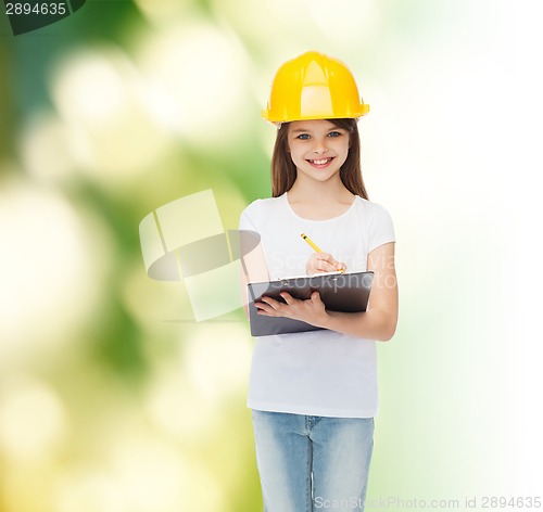 Image of smiling little girl in hardhat with clipboard