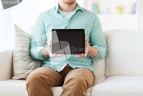Image of close up of man with tablet pc computer at home
