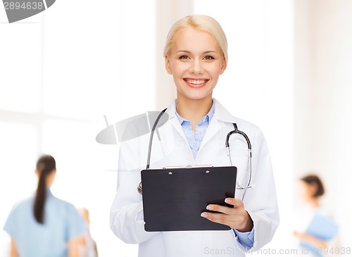 Image of smiling female doctor with clipboard