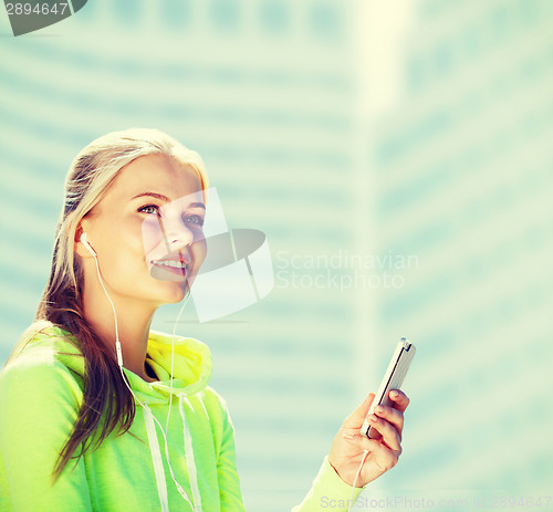 Image of woman listening to music outdoors