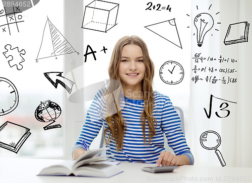 Image of student girl with book, notebook and calculator