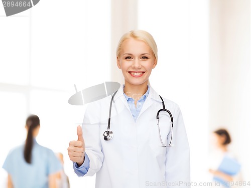 Image of smiling female doctor showing thumbs up