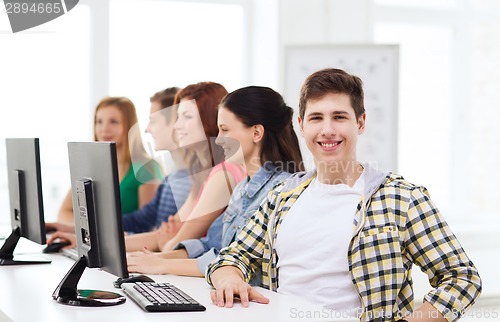 Image of male student with classmates in computer class